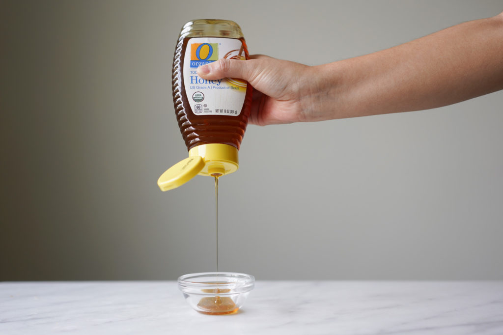 squeezing honey out of a bottle
