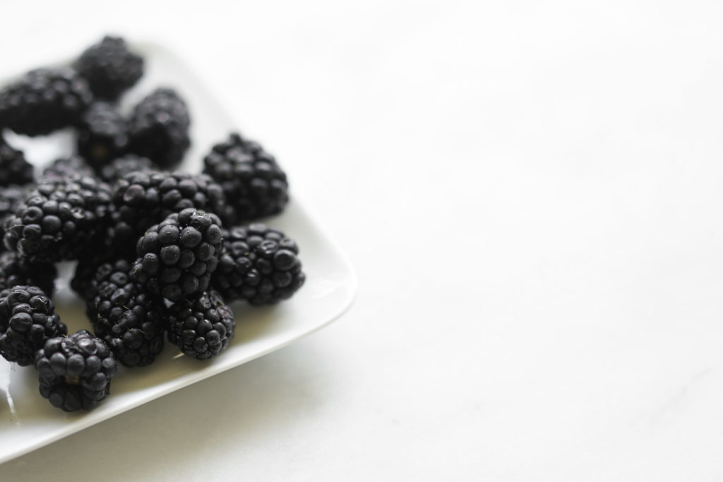 a small plate of blackberries