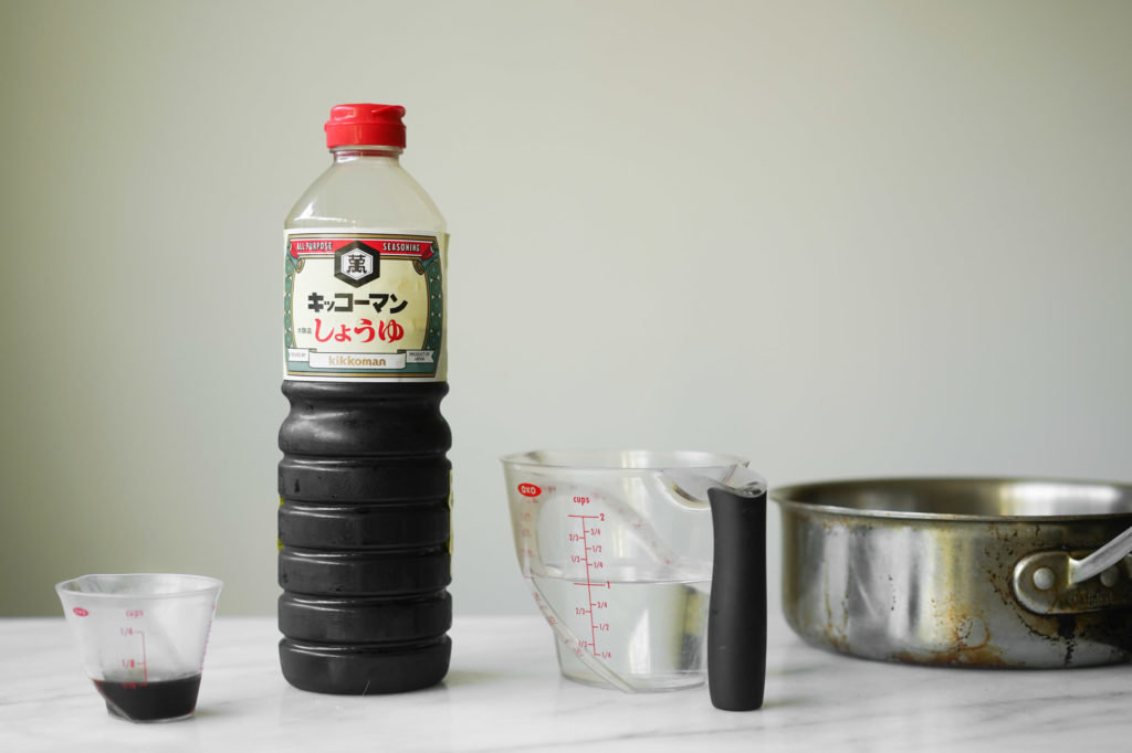 bottle of soy sauce and cup of water