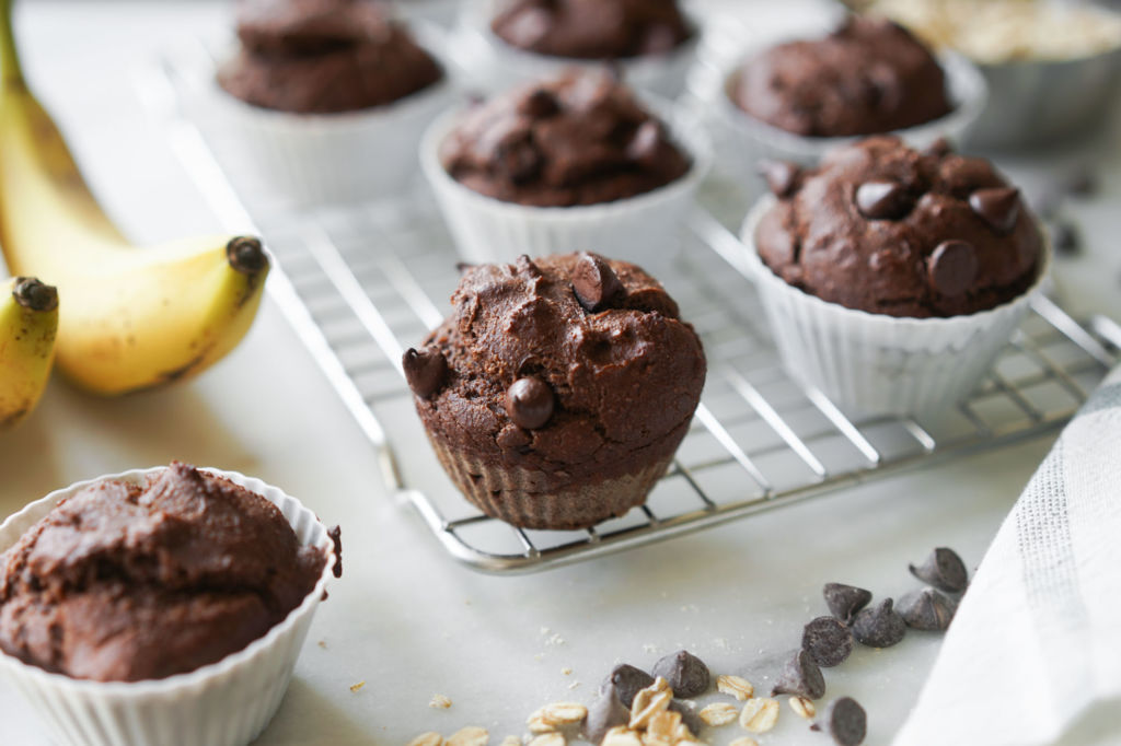 chocolate banana protein muffin cooling on a rack