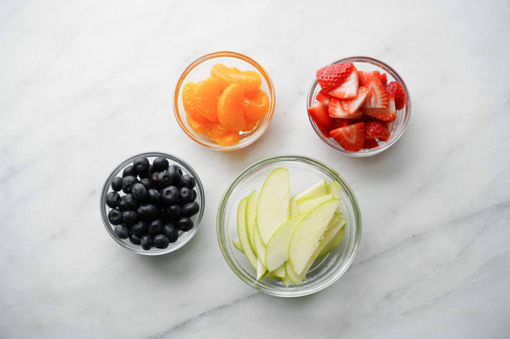 prepared fruit in glass bowls