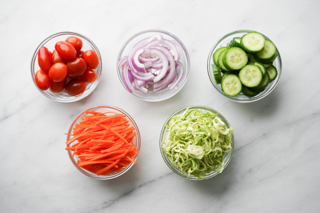 chopped veggies in glass bowls