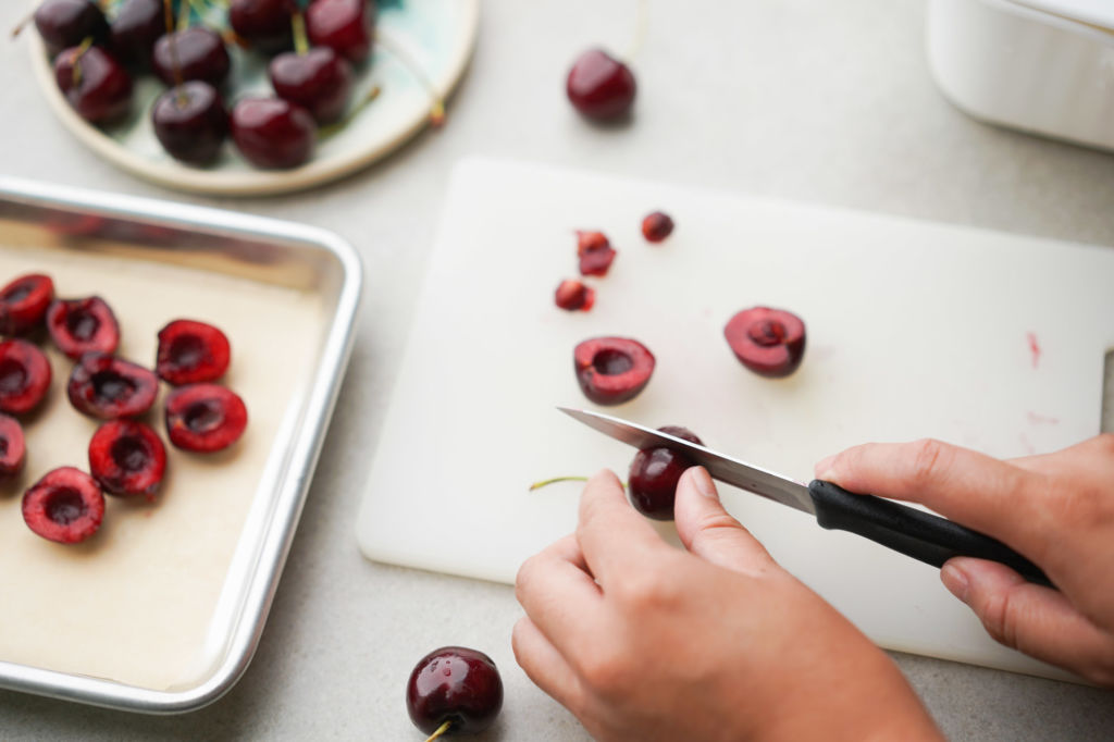 pitting cherries with a knife