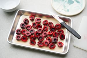 pitted cherries on parchment paper