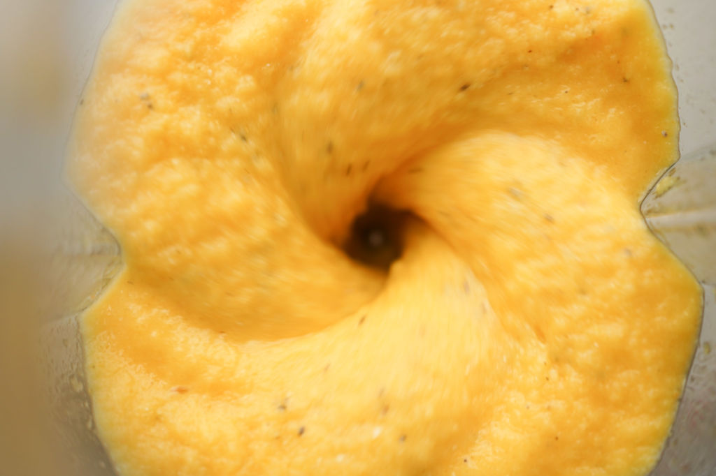 yellow smoothie inside a blender