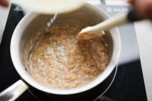 drizzling egg whites into oatmeal