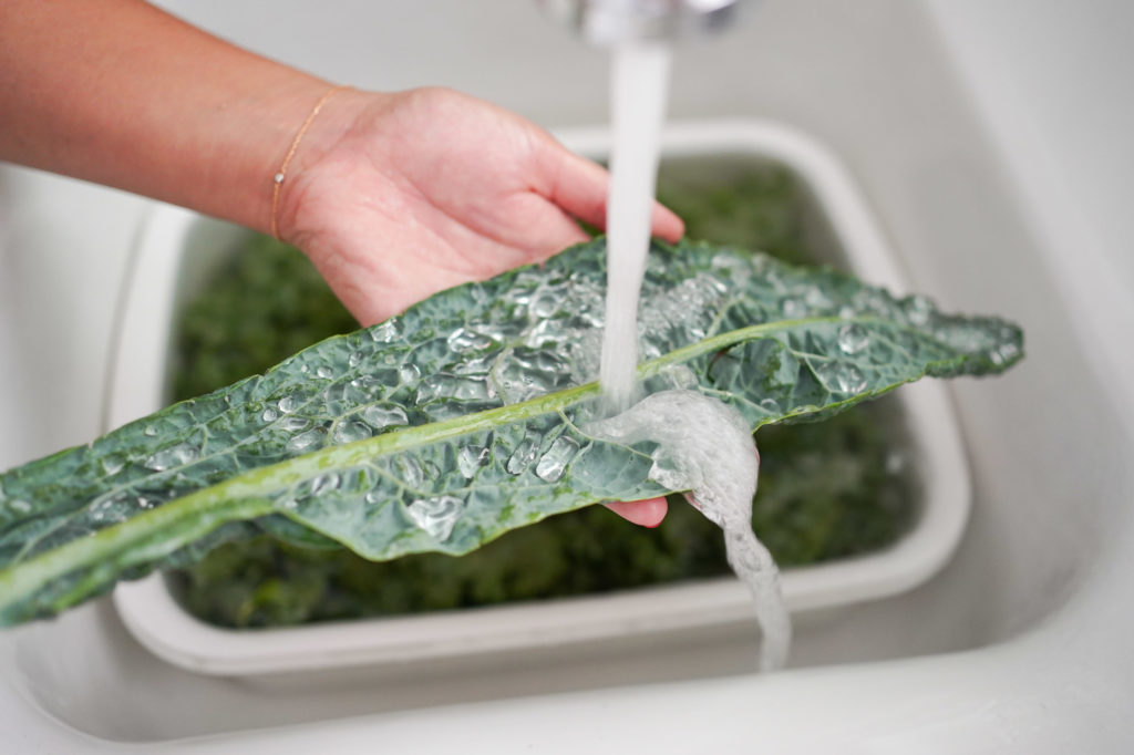washing kale under running water