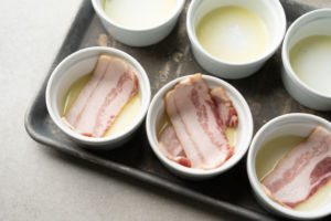 ramekins lined with butter and bacon