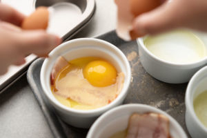 cracking egg into ramekin