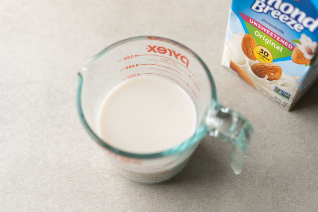 almond milk in measuring cup