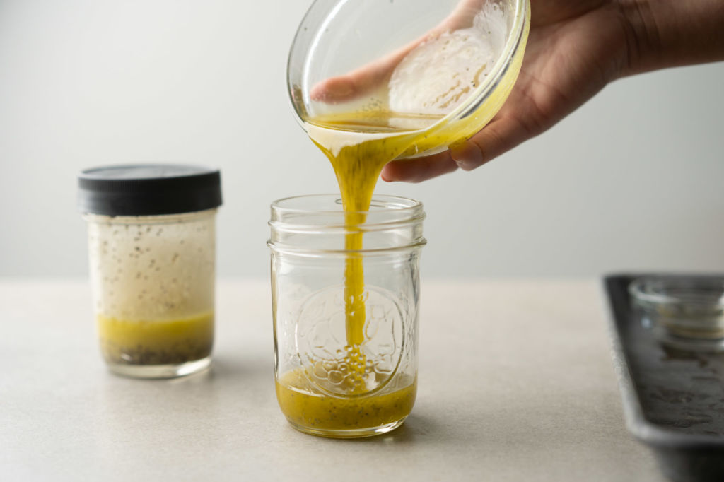 poppy seed dressing pouring into jars