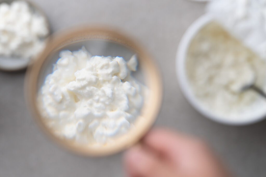 magnifying glass showing texture of cottage cheese
