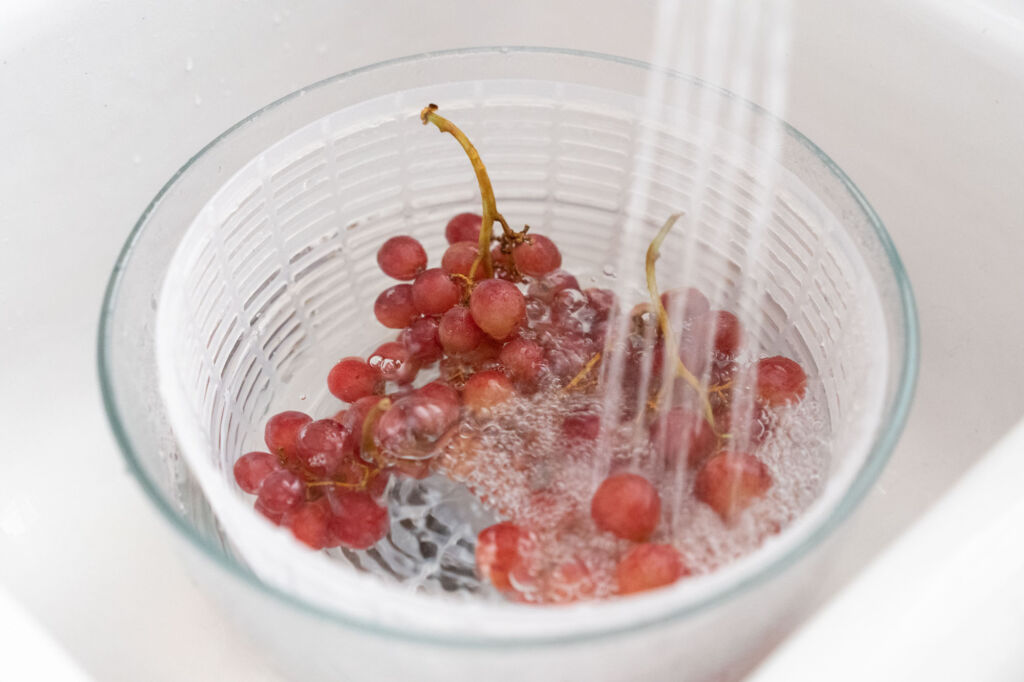 washing grapes in sink