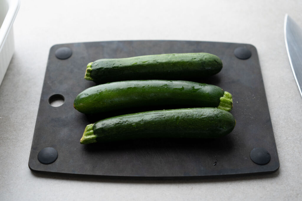 whole zucchini on a cutting board