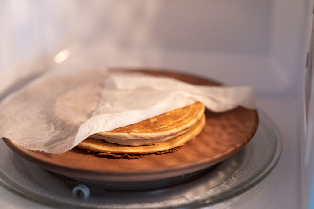 pancakes in microwave draped with paper towel