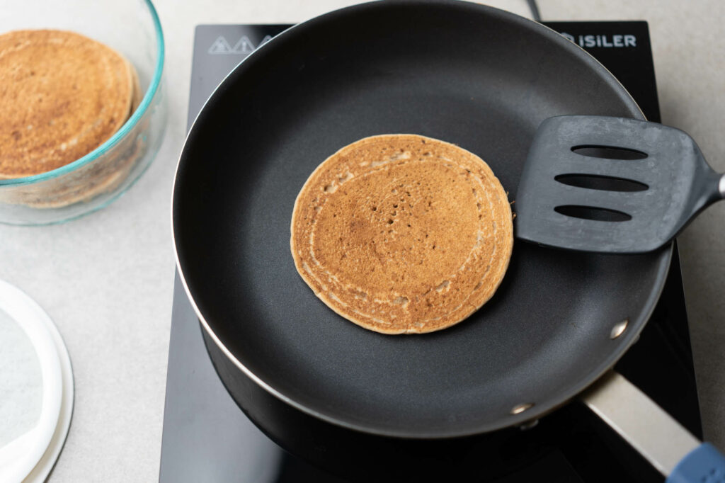 pancakes heating on a frying pan