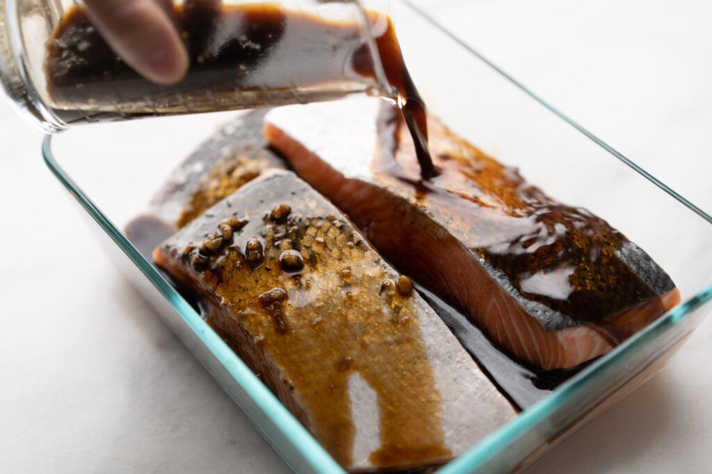 marinading salmon fillets in teriyaki sauce